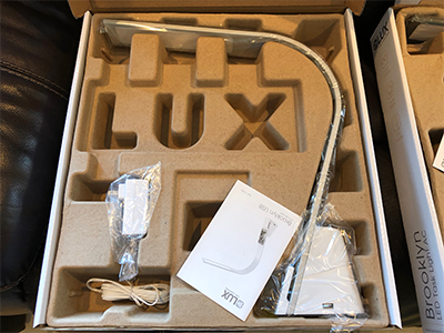 The LUX USB Task Lamp inside the manufacterer packaging and box